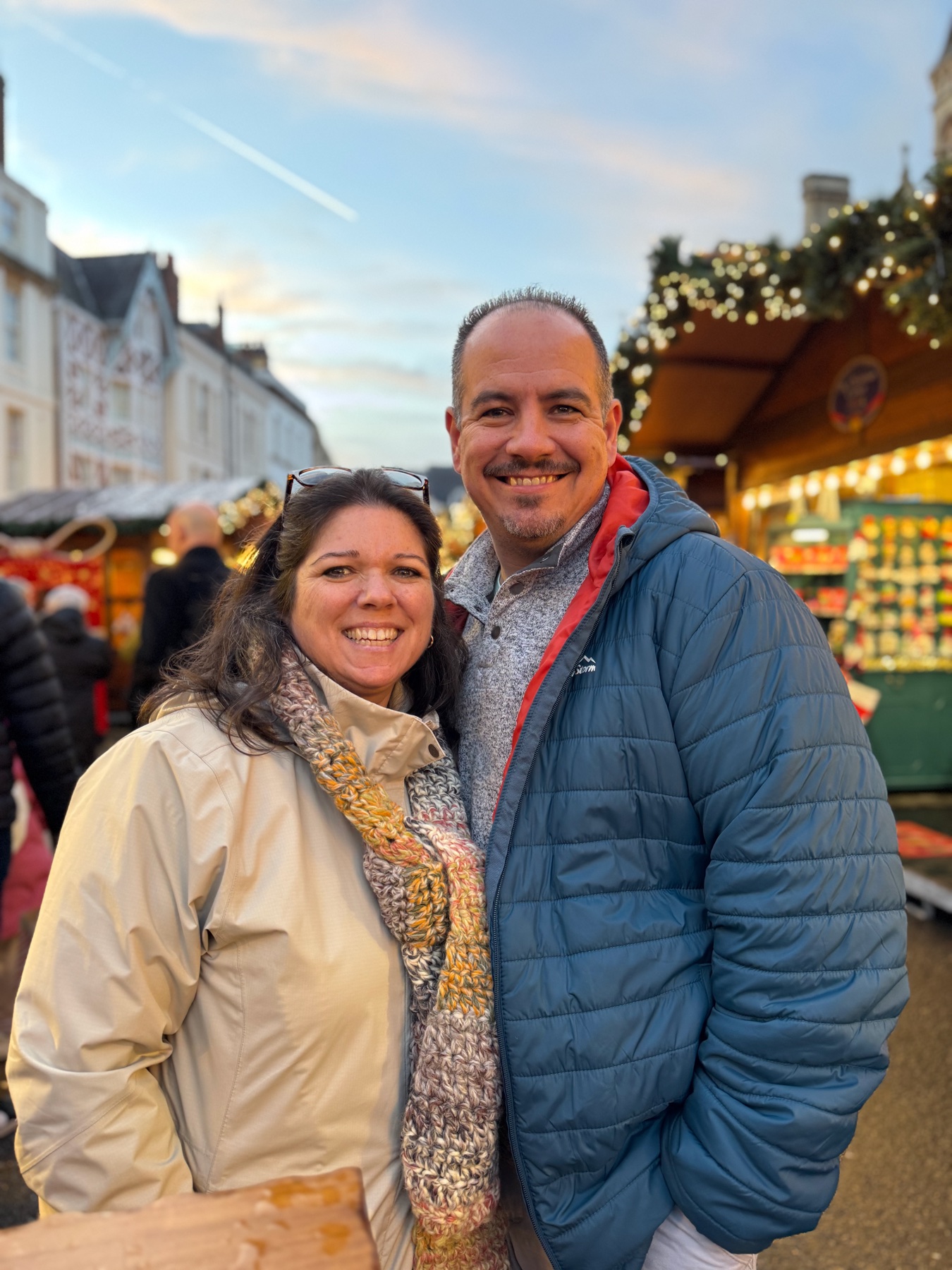 Jim and Rosa Byers smiling together at a holiday market